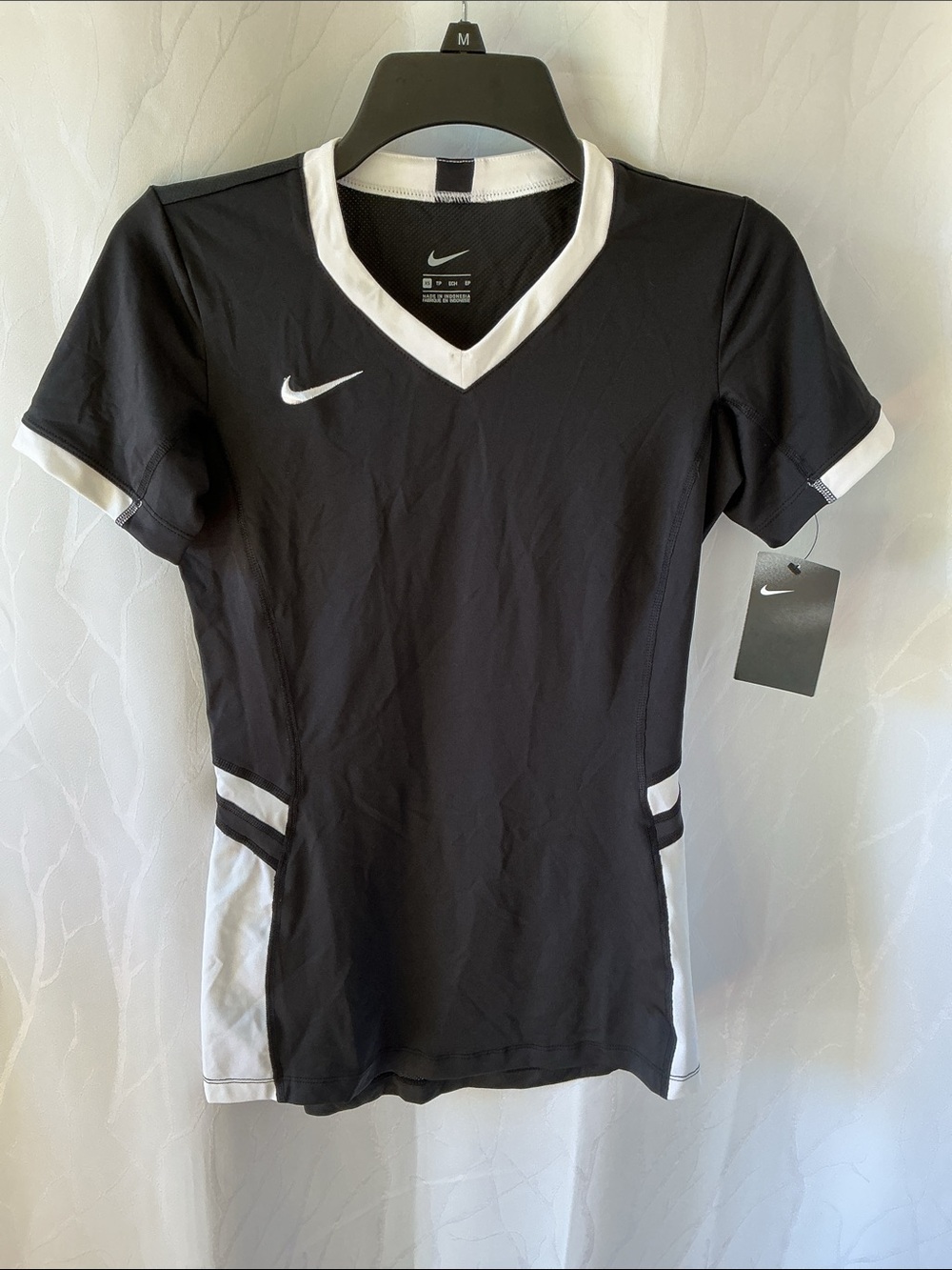 Nike woman’s Black Athletic V-Neck Shirt with White Accents. New